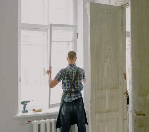 a man replacing a window