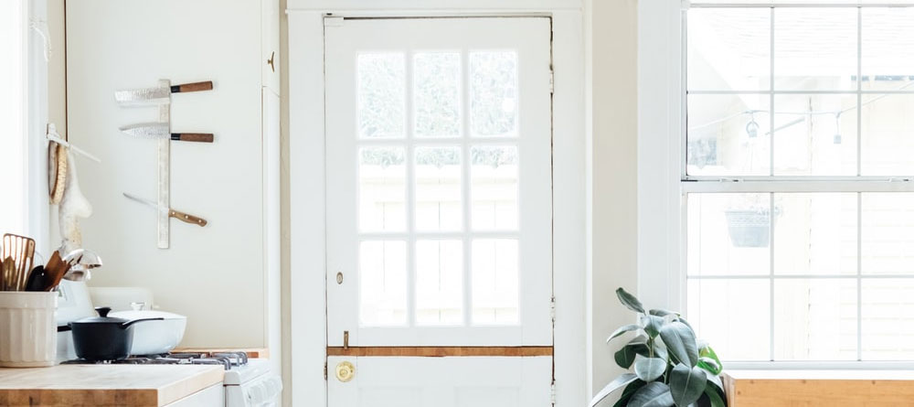 White walls with a door and window